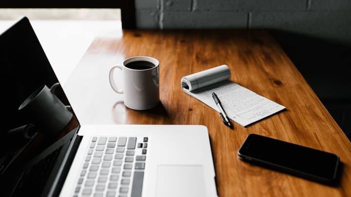 laptop, coffee and notepad on desk