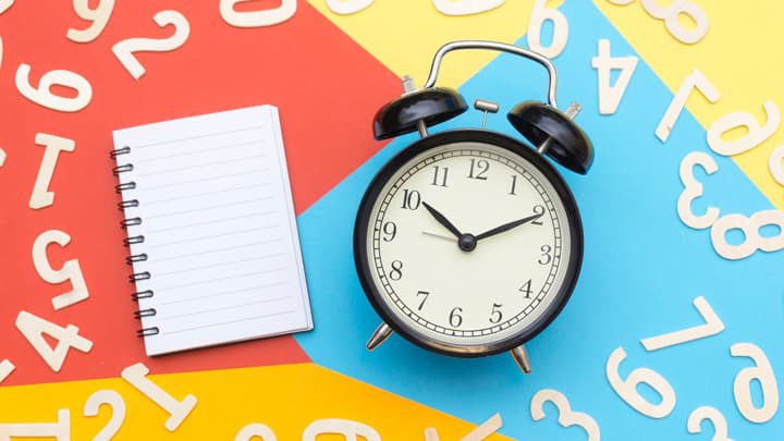 A notpad and an alarm clock with two bells