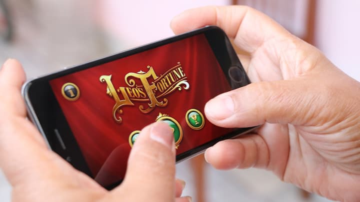 hands on mobile phone playing game