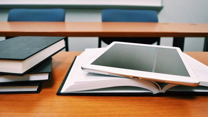 Book and tablet on desk