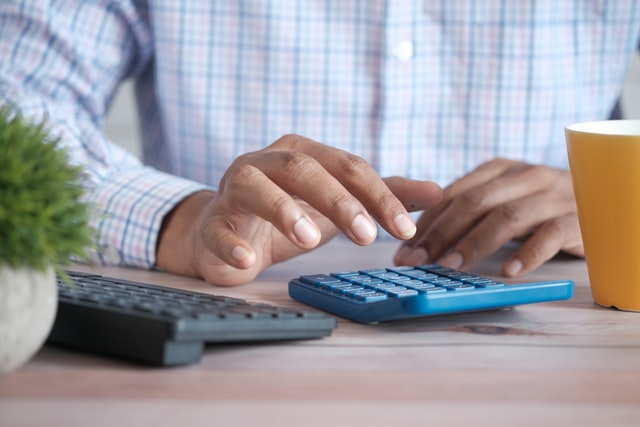 A man using a calculator