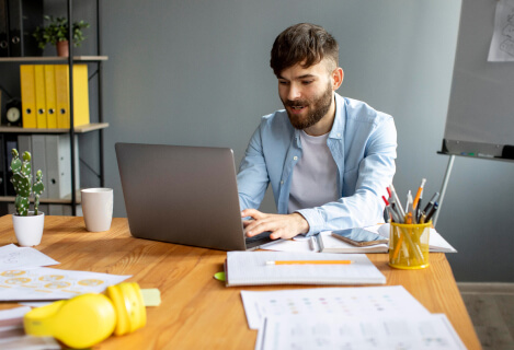 A man working on a laptop at a desk