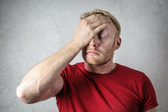 Frustrated man in red top