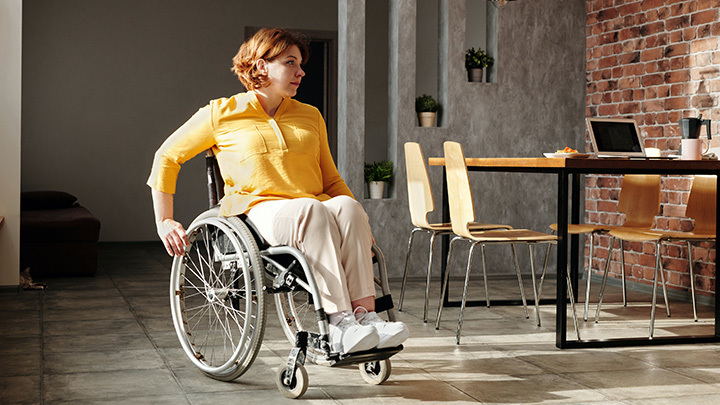 Wheelchair user working in cafe