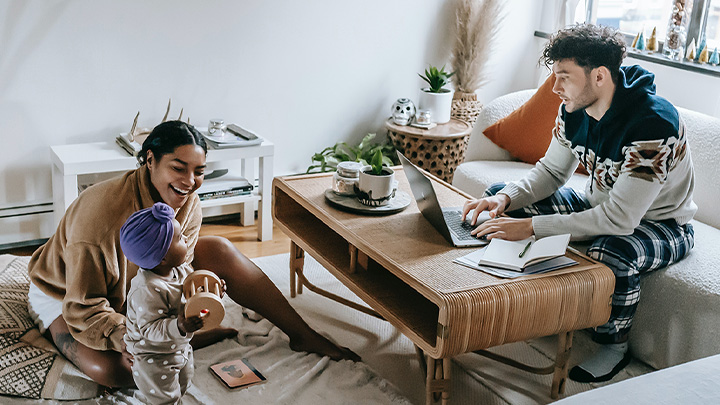 Man woman and child playing in lounge with papers on table