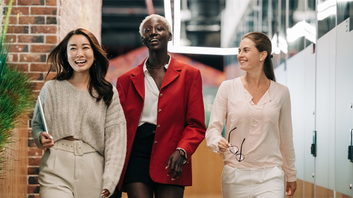 Three women walking and laughing