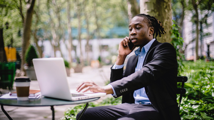 man outside working talking on mobile phone