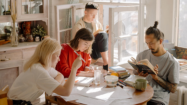 Students working around table at home