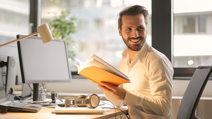 Man at desk with book