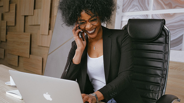 Woman at desk on phone