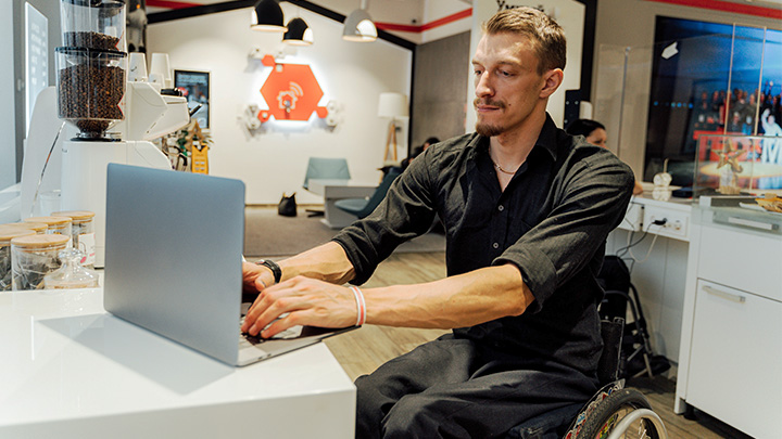 Man in wheelchair working at desk