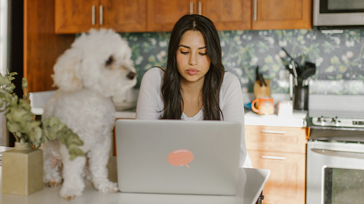 Woman and dog at laptop