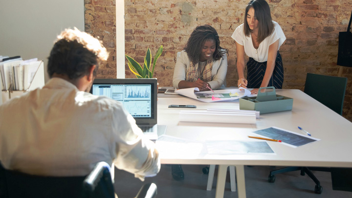 People in office working round a large table