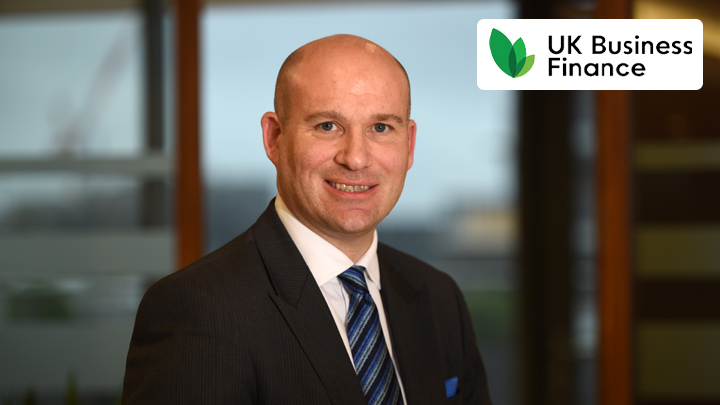 Man smiling with UK Business Finance logo in corner