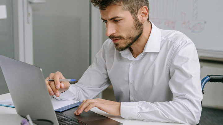 Man working at laptop at desk