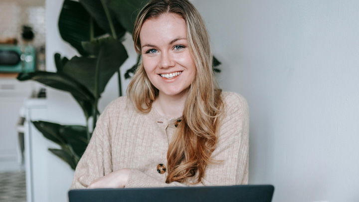 woman working smiling over laptop