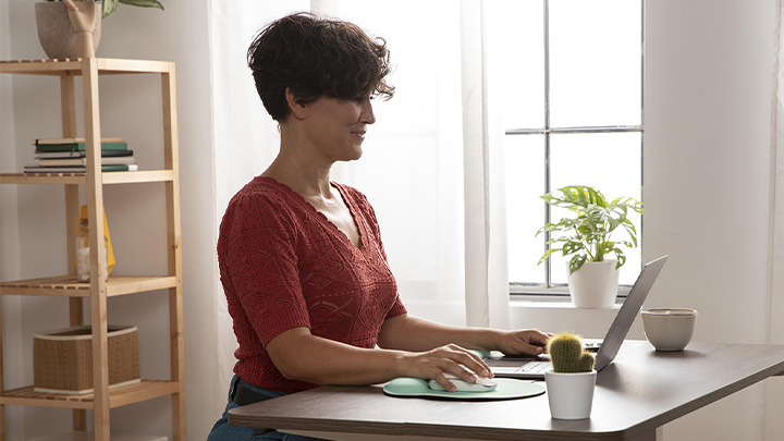 woman working at laptop on desk