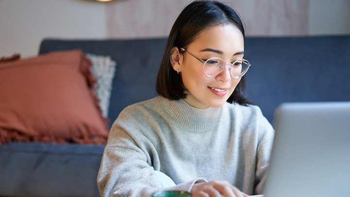 Woman working from home, working on a laptop