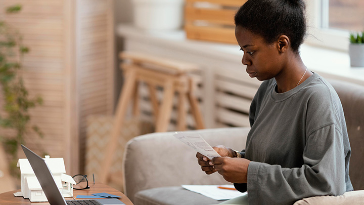 A woman sitting on a sofa studying